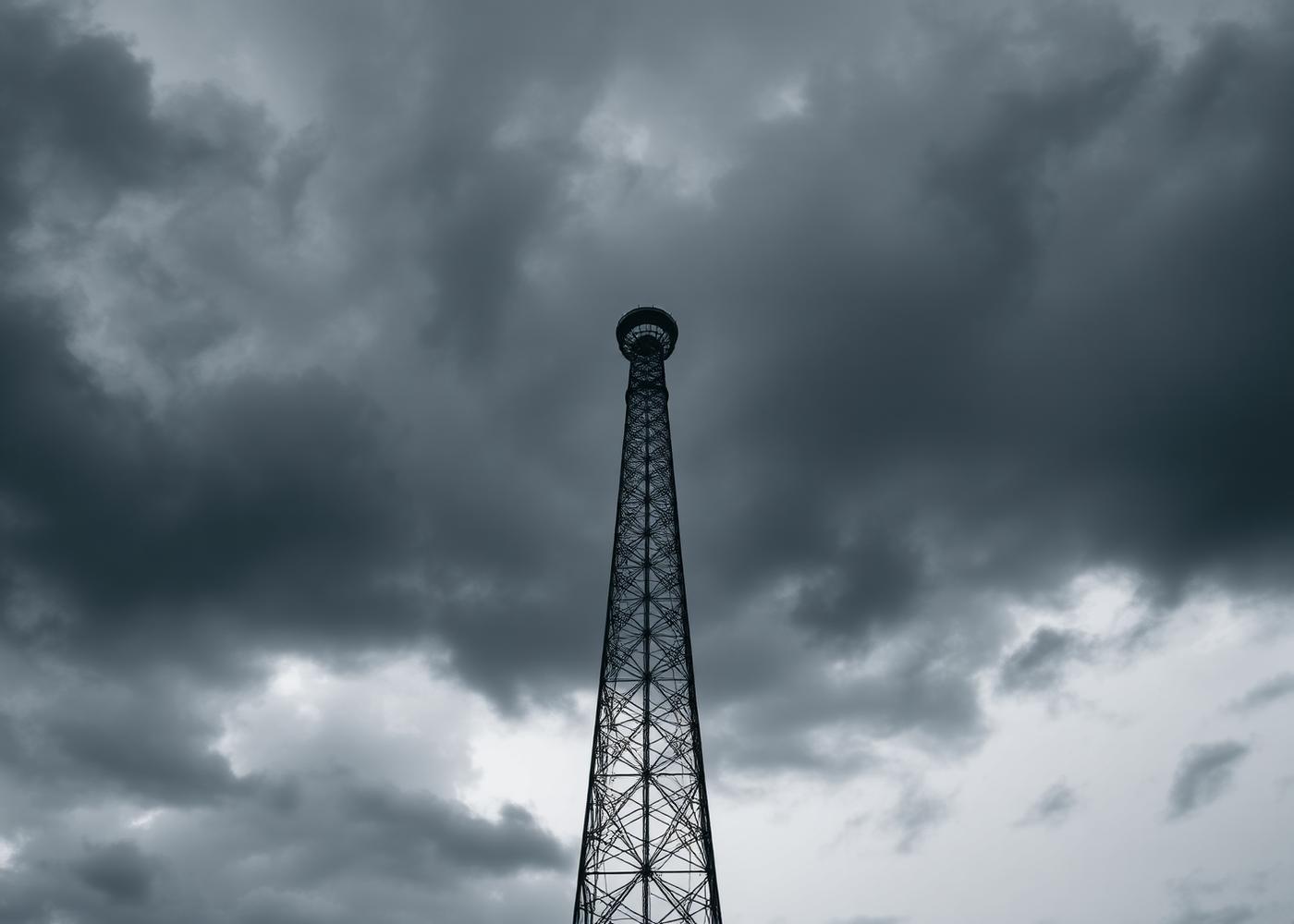 Cell tower against dark storm clouds